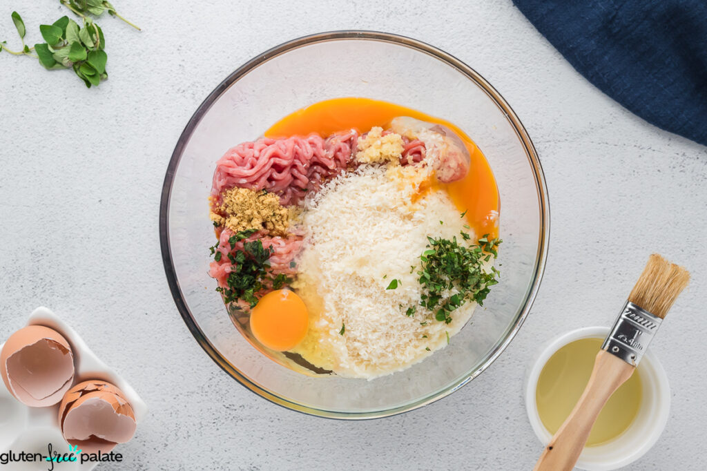 Meatball ingredients added to a bowl.