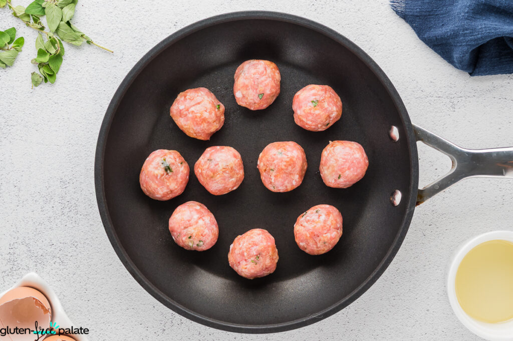 Gluten-free turkey meatballs in a frying pan.