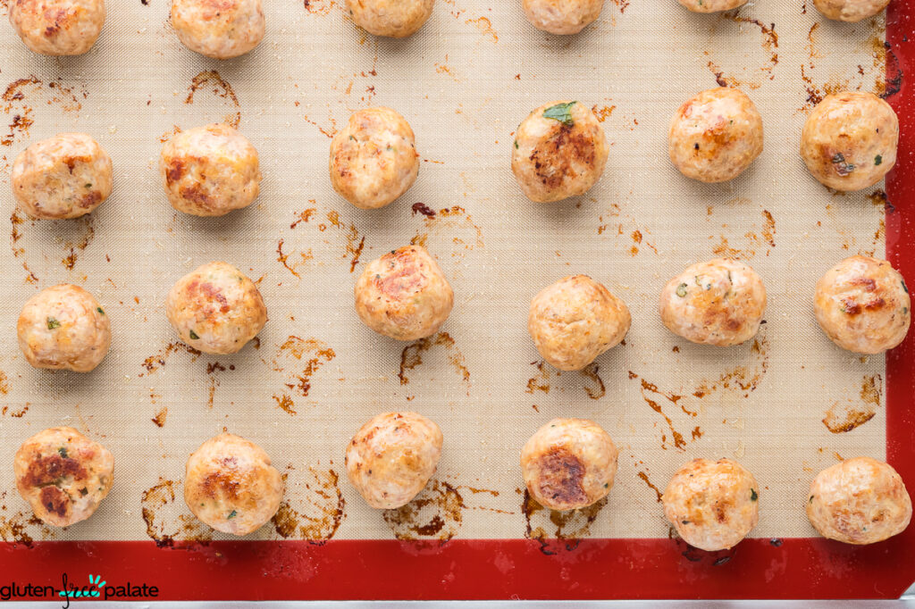 Gluten-free turkey meatballs on a baking tray.