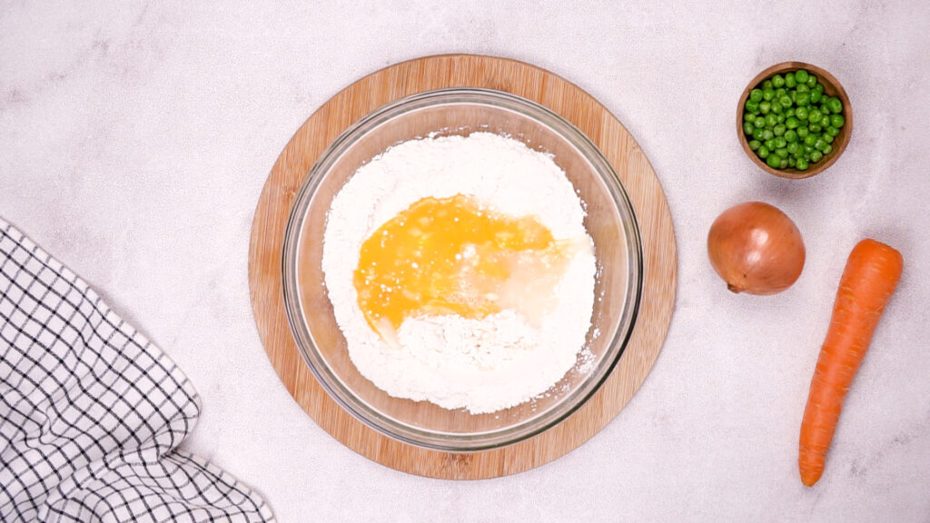 Bowl of gluten-free flour with beaten egg being mixed in.