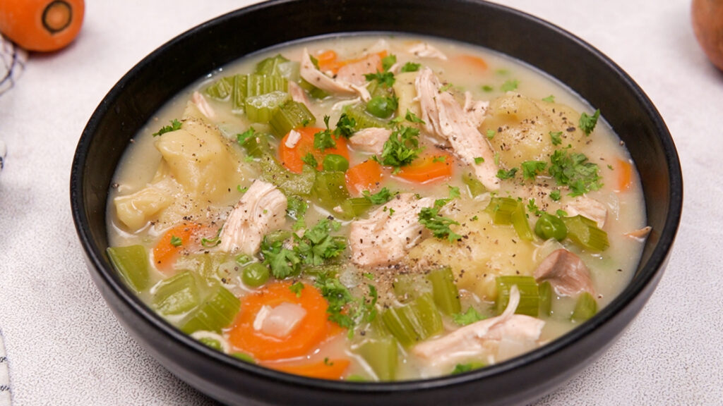 Close-up of the finished gluten-free chicken and dumplings with vegetables in broth.