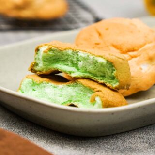 Green cloud bread sliced in half showing soft inside.