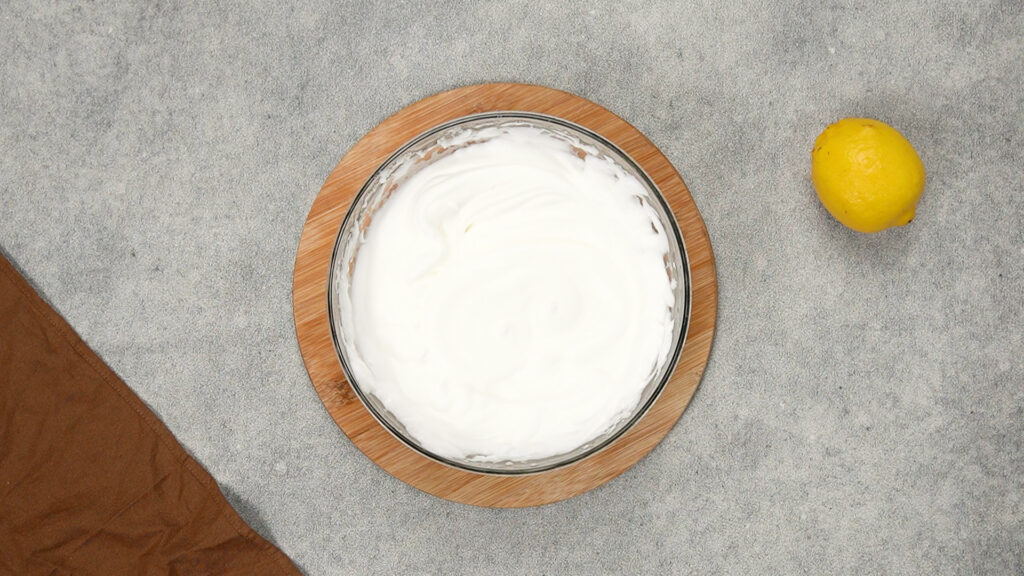 Glossy, stiff egg white mixture in a glass bowl, ready for folding in cornstarch for gluten-free cloud bread.