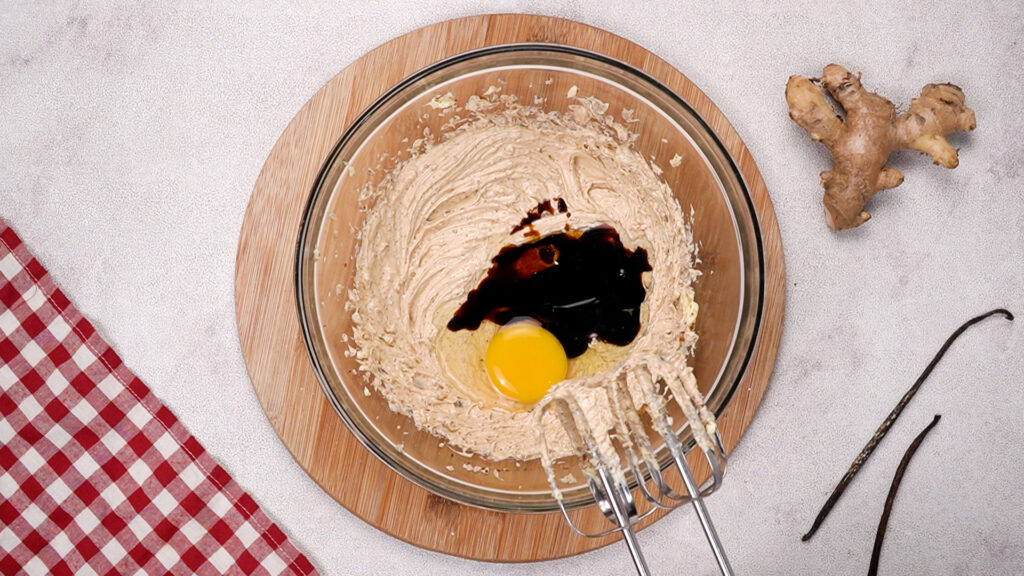 Creamed butter and sugar mixture with egg, molasses, and vanilla extract added.