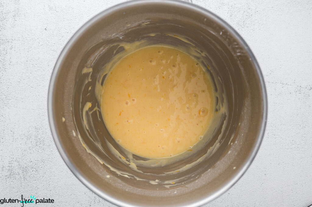 Smooth, gluten-free lemon elderflower cupcake batter mixed together in a stainless-steel mixing bowl.