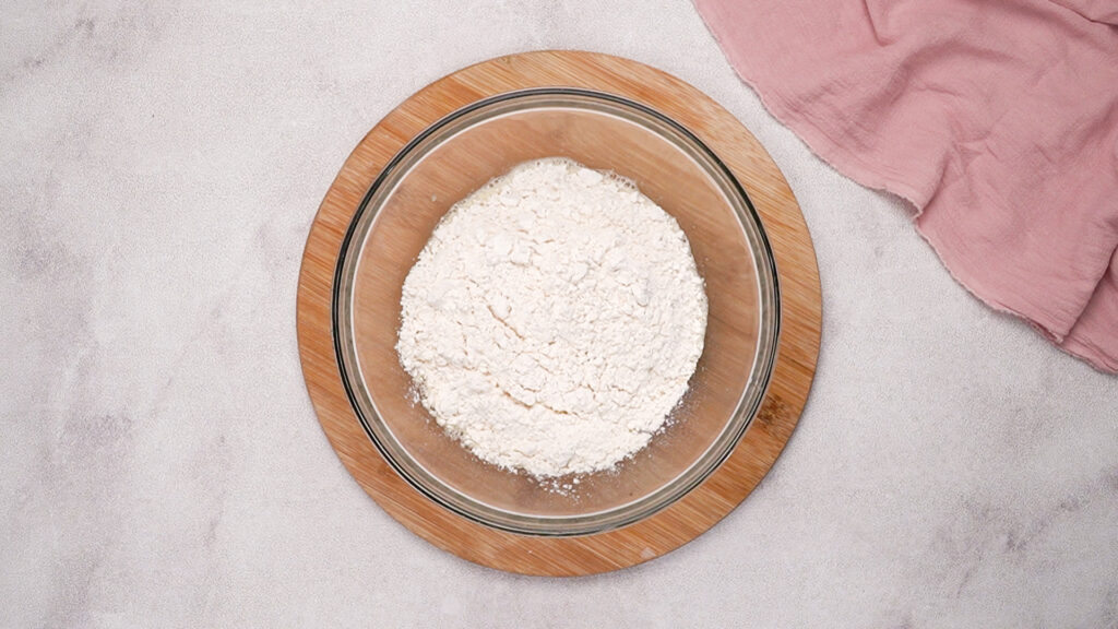 A bowl filled with gluten-free flour, about to be combined into the wet mixture.