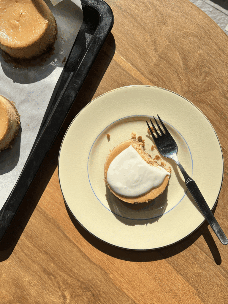 A plate with a fork and a gluten-free cheesecake bite on it.