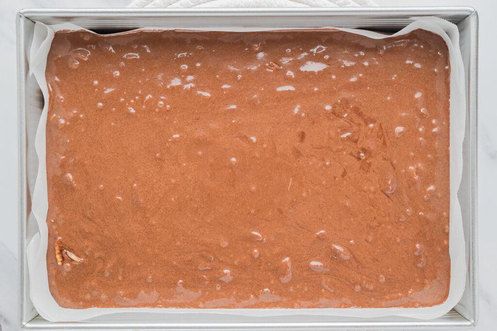 Fudge in baking pan with parchment papeer.