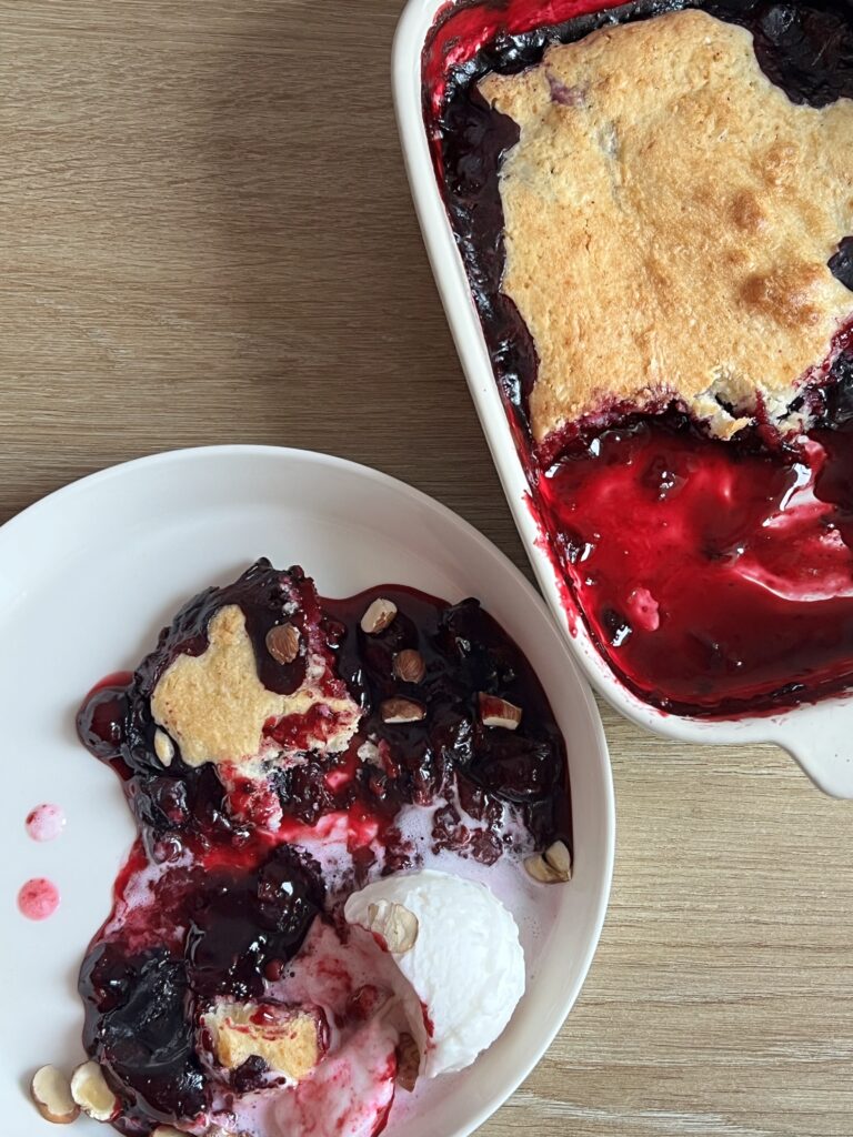 Blueberry cobbler dished up from the casserole dish.