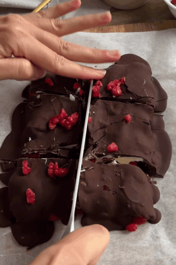 Cutting the Raspberry Chocolate Bark into pieces.