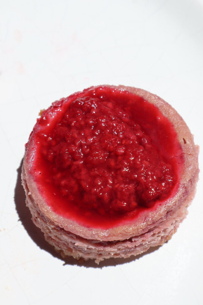 Close up of one mini raspberry cheesecake.