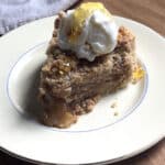 Slice of gluten-free apple crumb pie served with ice cream.