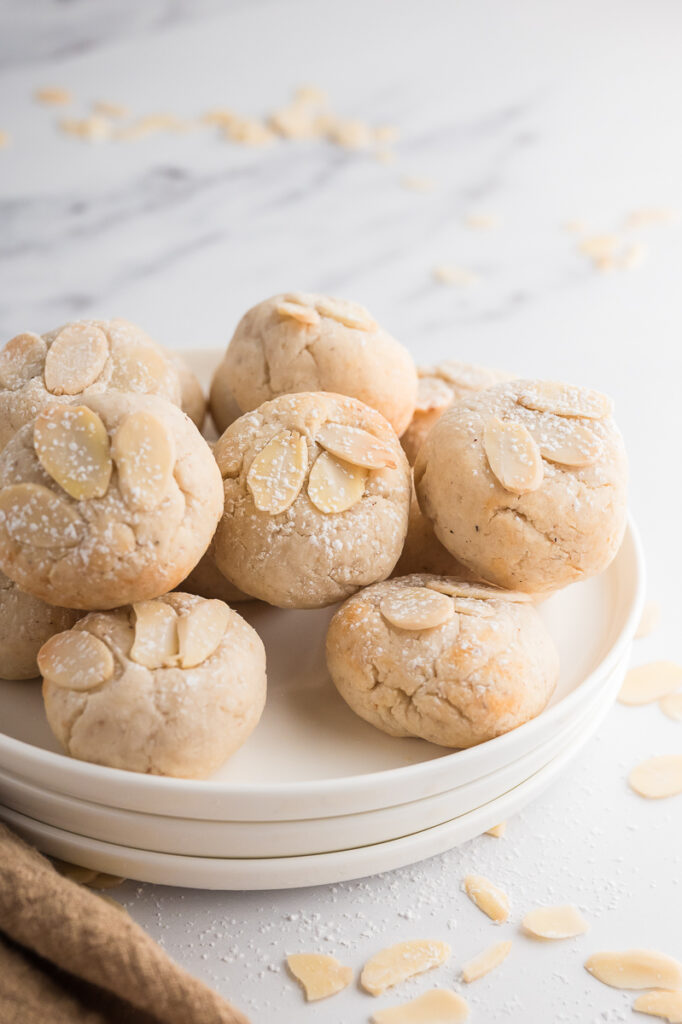 A plate filled with almond cookies.