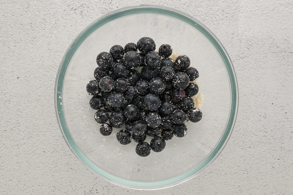 Folding blueberries into almond flour muffin batter with a rubber spatula
