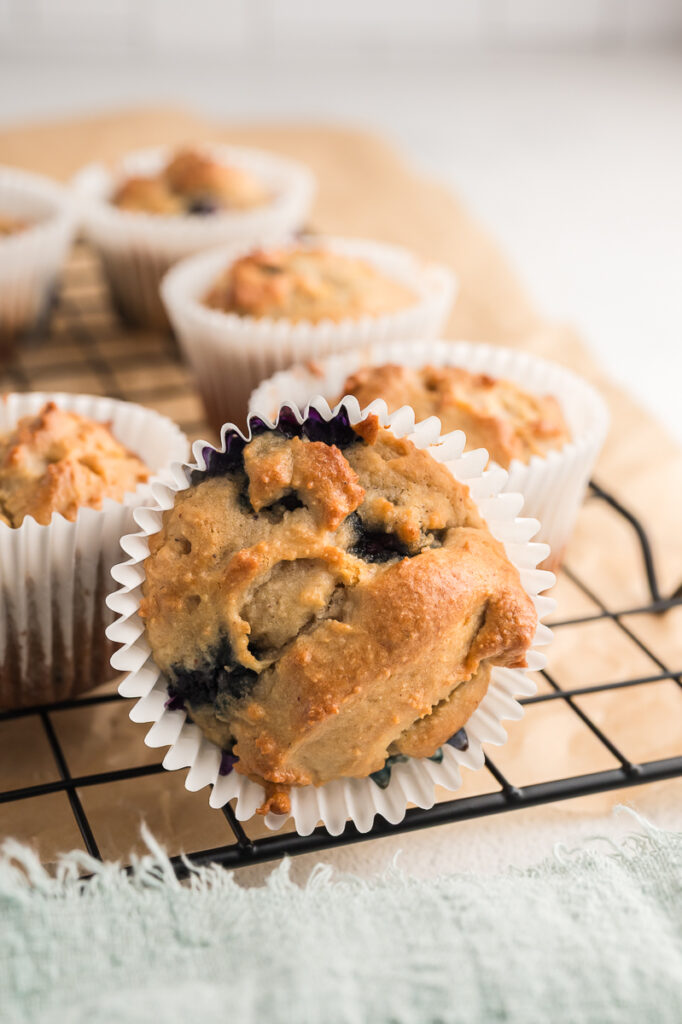 Almond flour muffin on a cooling rack showing a golden domed top