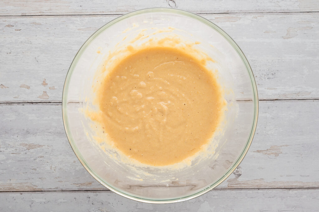 Thick almond flour pancake batter mixed in a bowl with psyllium husk and baking powder