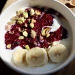 Finished blueberry chia yogurt bowl with banana and nuts.