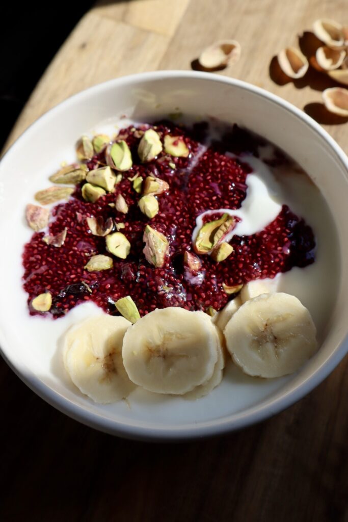 Finished blueberry chia yogurt bowl with banana and nuts from above