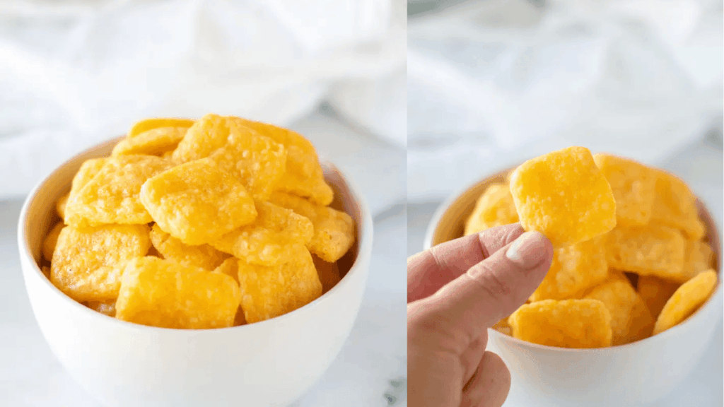 A bowl of gluten-free cheez it crackers next to a photo showing someone holding one of the crackers.