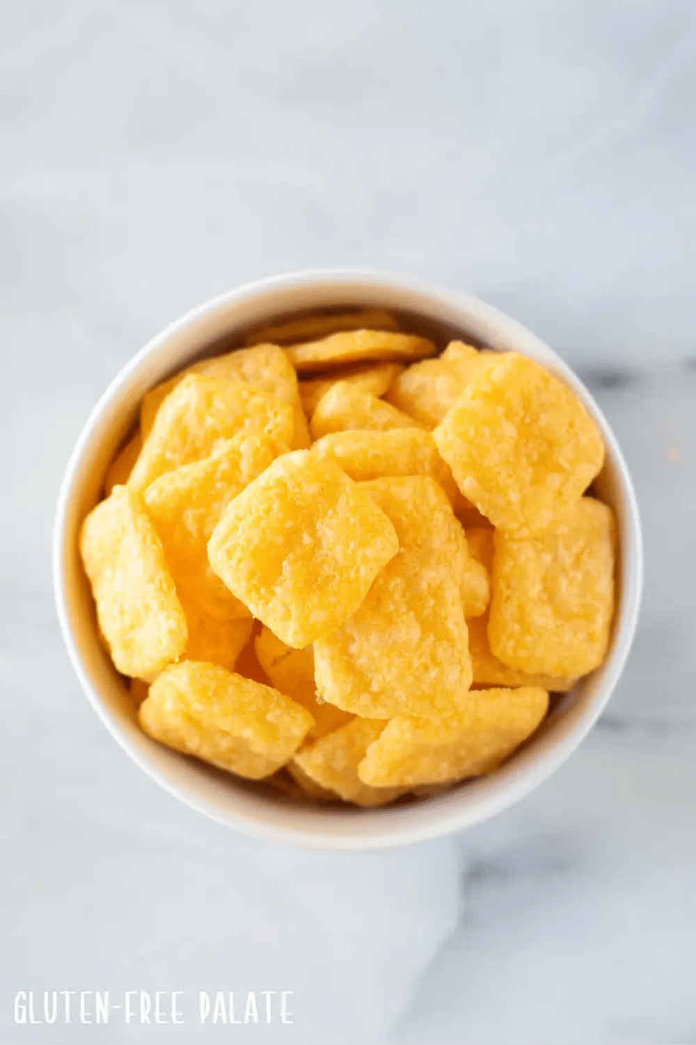 A bowl of gluten free cheez it crackers shown from above